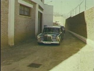 Rawat (Maharaji) Arriving At His Barbed Wire Compound in Stretch Limo